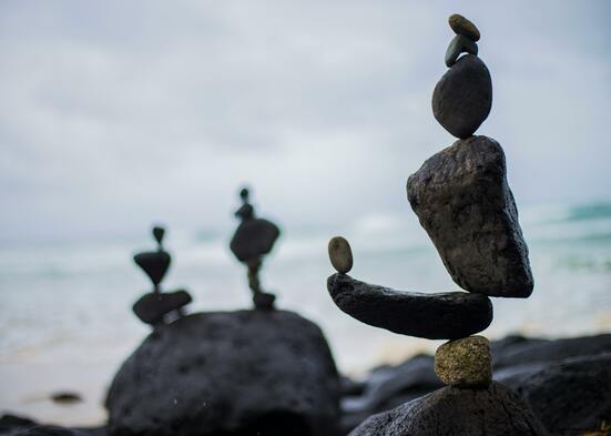 Artistic rock balancing on a serene beach