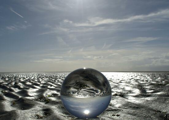 Crystal sphere reflecting a tranquil seaside landscape